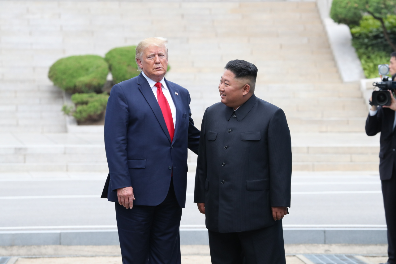 Former US President Donald Trump (left) and North Korean leader Kim Jong-un meets at the inter-Korean border truce village of Panmunjom on June 30, 2019. (Yonhap)