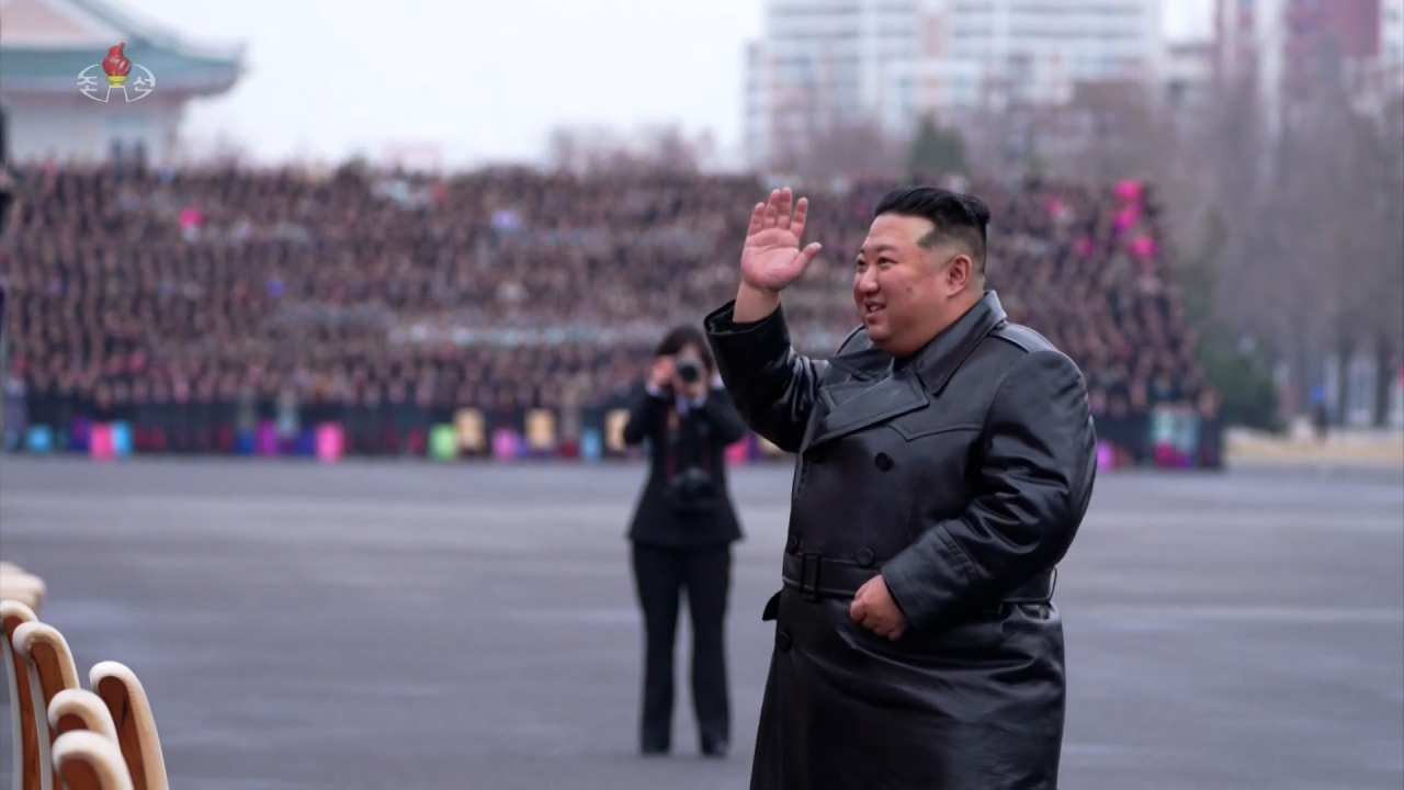 This screen grab from Korean Central Television shows North Korean leader Kim Jong-un waving his hand at the Meeting of Mothers in Pyongyang on Dec. 8. (Yonhap)
