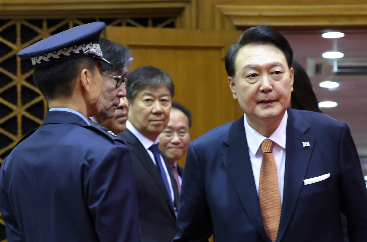 President Yoon Suk Yeol (right) walks out of the Seoul Air Base in Seongnam, Gyeonggi Province, as he returned from his state visit to the Netherlands on Friday. (Yonhap)