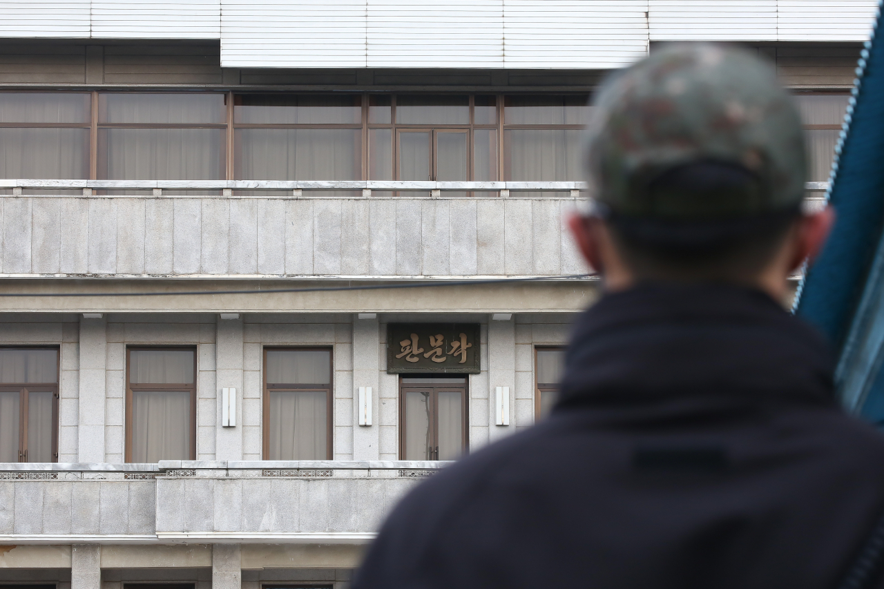 A security guard looks at the Panmungak building on the north side of the Joint Security Area on Nov. 30. (Joint Press Corps)