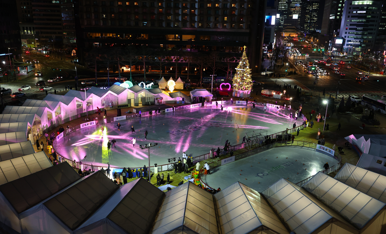 Seoul city government opened its skating rink on Friday. People enjoy night skating with Christmas trees at the Seoul Plaza braving the coldest day of this winter. (Yonhap)