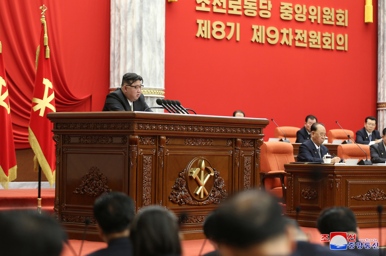 This photo, on Thursday shows the North's leader Kim Jong-un (left) attending the ninth plenary meeting of the eighth Central Committee of the ruling Workers' Party of Korea the previous day. (Yonhap)