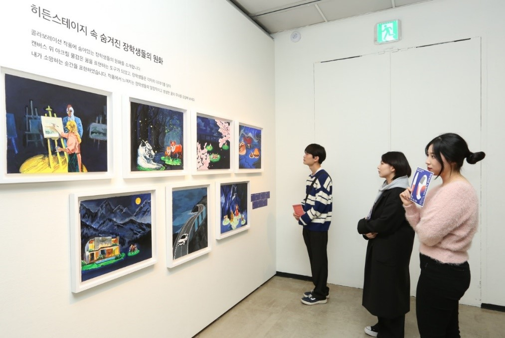 Attendees view the artwork of Dream Gream students at an exhibition named 