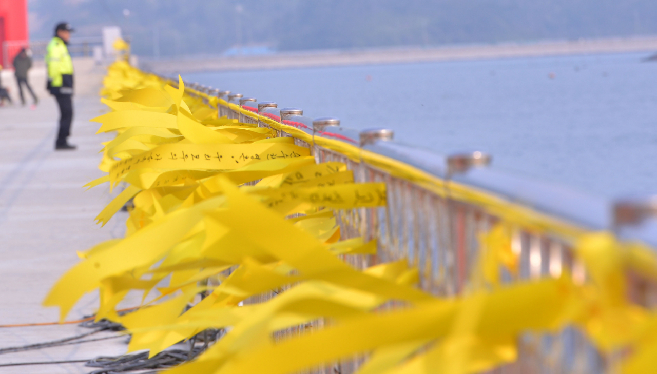 Yellow ribbons, symbolizing wishes for the safe return of the missing passengers and condolences for the victims, flutter in the wind at Paengmok Port, near where the Sewol ferry capsized and sank, on April 24, 2014. The Korea Herald