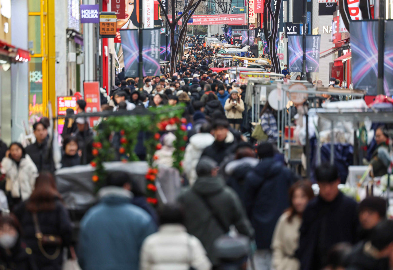 On Sunday, the last day of 2023, the streets of Myeong-dong, Jung-gu, Seoul are crowded with people. (Yonhap)