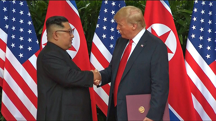 Former US President Donald J. Trump and Chairman Kim Jong Un of the State Affairs Commission of the Democratic People's Republic of Korea (DPRK) shake hands after signing an agreement at a historic summit in Singapore on June 12, 2018. (Ministry of the Interior and Safety Presidential Archives)