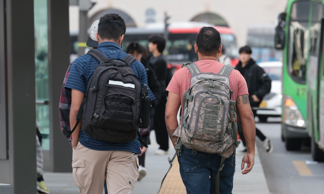 Passersby are spotted wearing short-sleeved shirts on Dec. 8 near Gwanghwamun Square, Seoul as daytime average temperatures reached up to 16.8 degrees Celsius. (Yonhap)