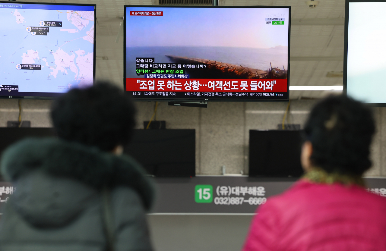 Passengers watch the news on North Korea's latest artillery provocation at a ferry terminal in Incheon, 27 kilometers west of Seoul, on Friday. (Yonhap)