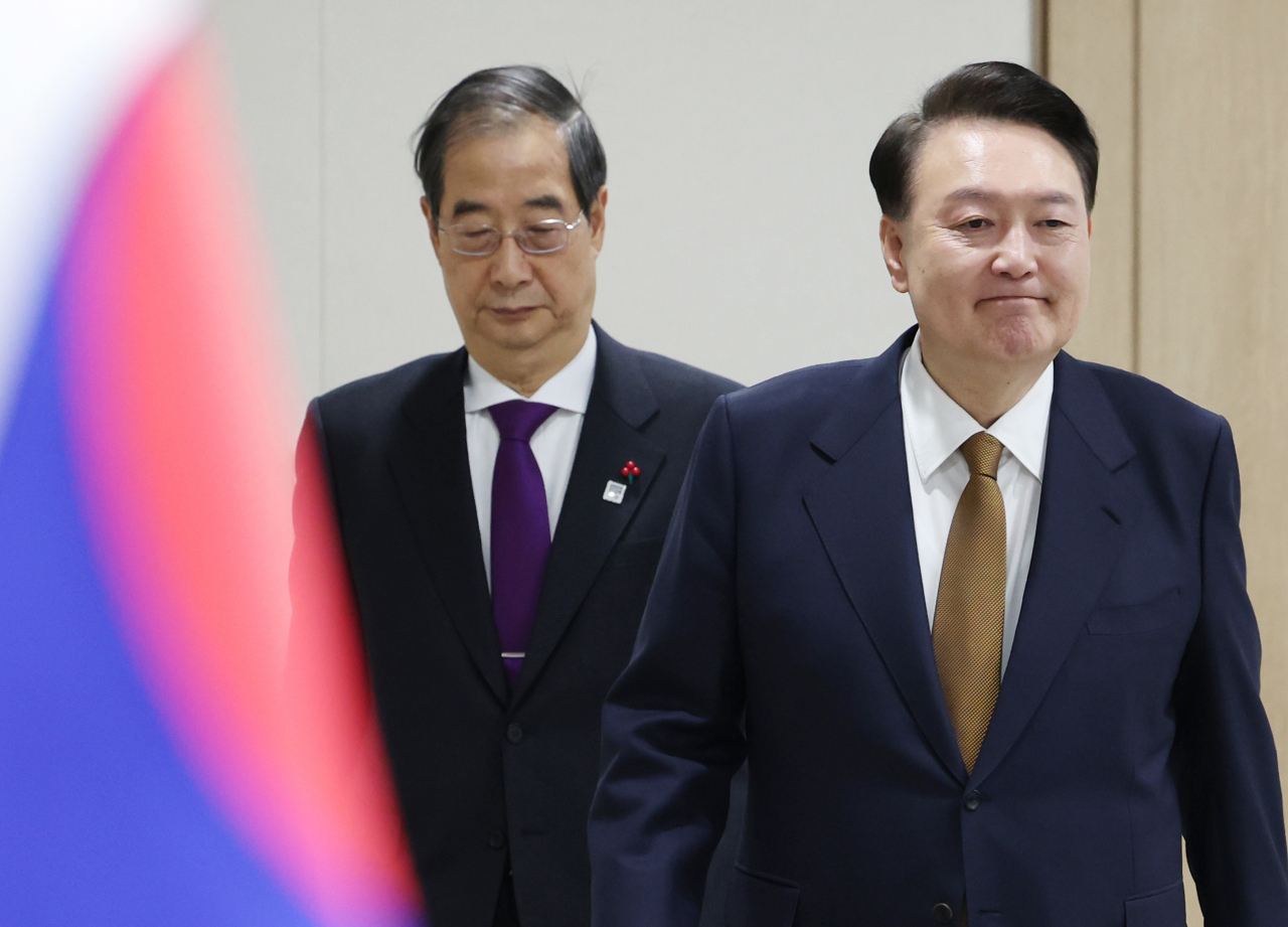President Yoon Suk Yeol (right) and Prime Minister Han Duck-soo attend a Cabinet meeting held at the presidential office in Seoul on Tuesday. (Yonhap)