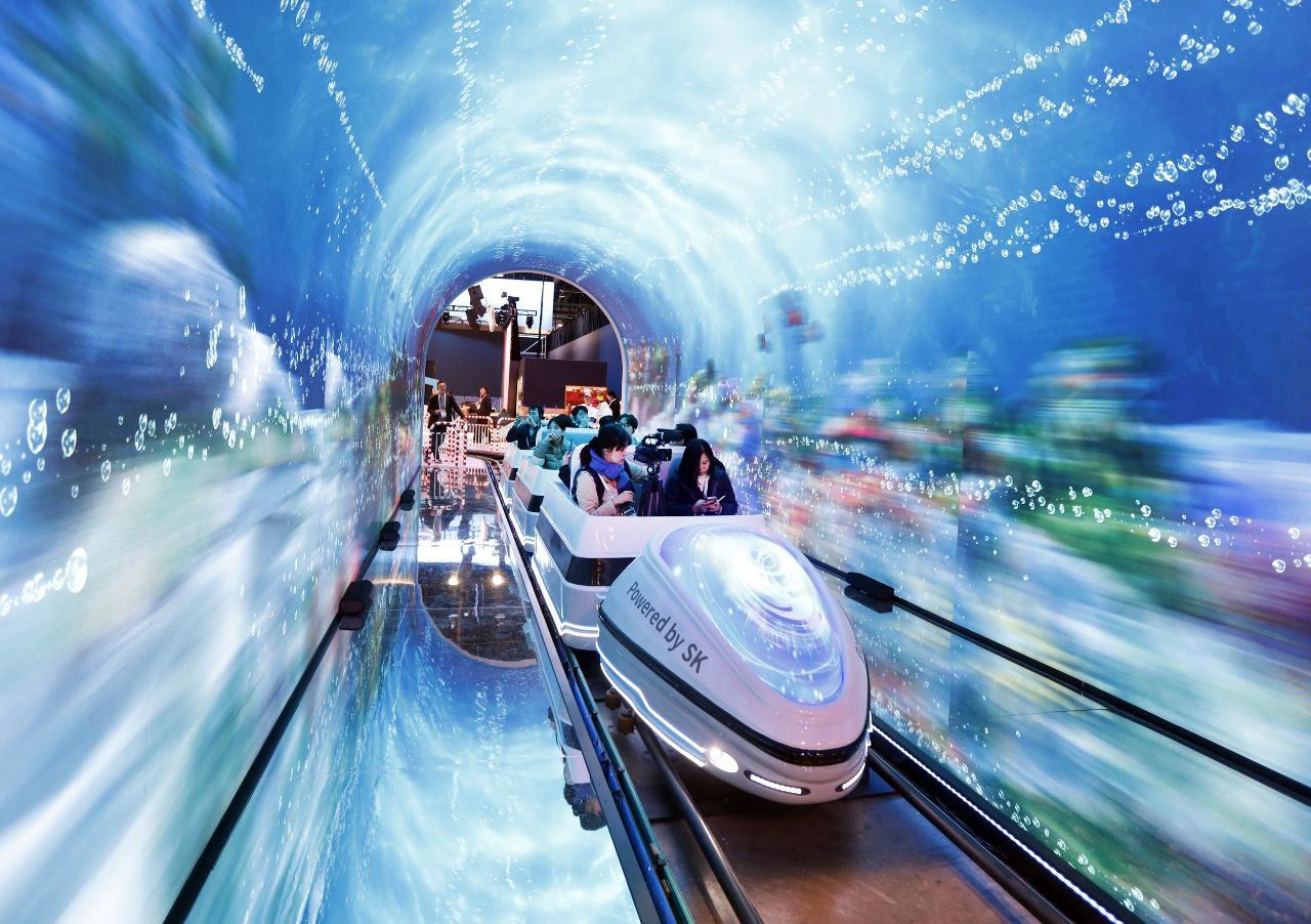 Visitors ride a renewable energy-powered train in the “Train Adventure” zone at SK Group's pavilion at the CES 2024 in Las Vegas. (SK Group)