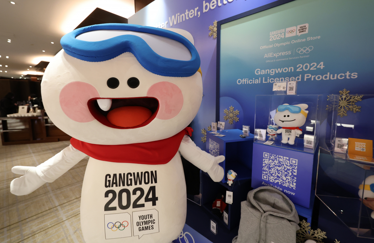 Moongcho, the mascot for the Gangwon 2024 Winter Youth Olympic Games, poses next to souvenirs for the event in this Jan. 4 photo taken in Seoul. (Yonhap)