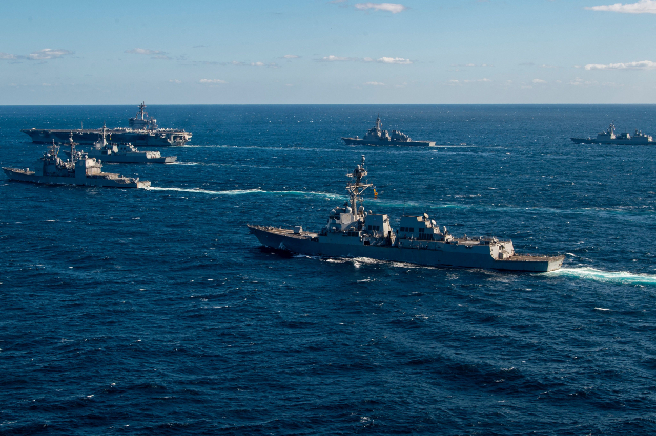 This undated handout photo taken by the US Navy and released on Thursday by the Joint Staff Office of the Defense Ministry of Japan shows the US Navy USS Kidd (front right) following the US Navy aircraft carrier USS Carl Vinson (back left) as they take part in three-day trilateral military maritime exercises with the navies of Japan and South Korea, at an undisclosed location in the Pacific Ocean. (AFP-Yonhap)