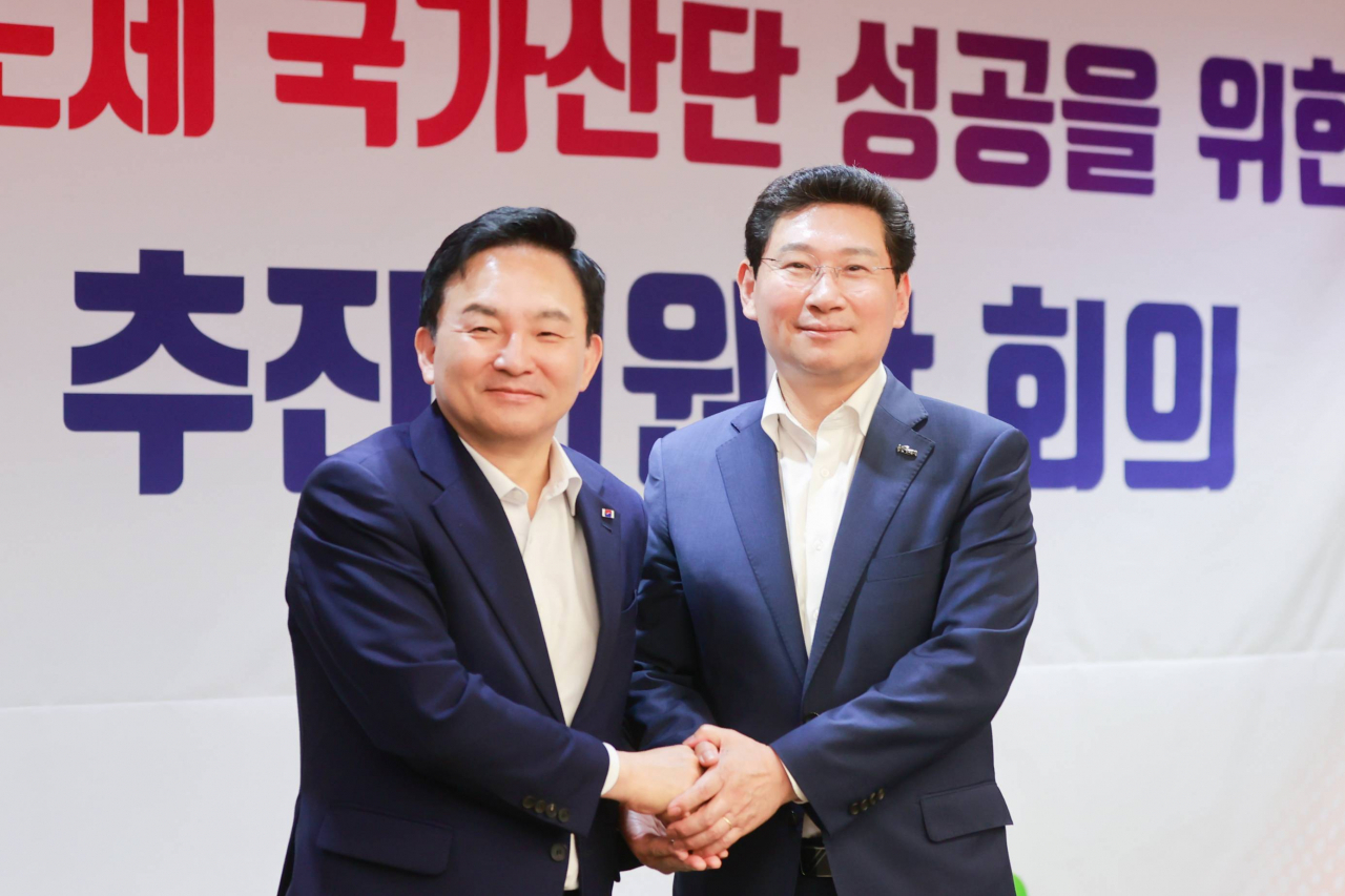 Yongin Mayor Lee Sang-il (right) shakes hands with the then-Minister of Land, Infrastructure and Transport Won Hee-ryong at a ceremony for the creation of the Yongin Semiconductor Industrial Complex in Giheung. (Yongin Special City)
