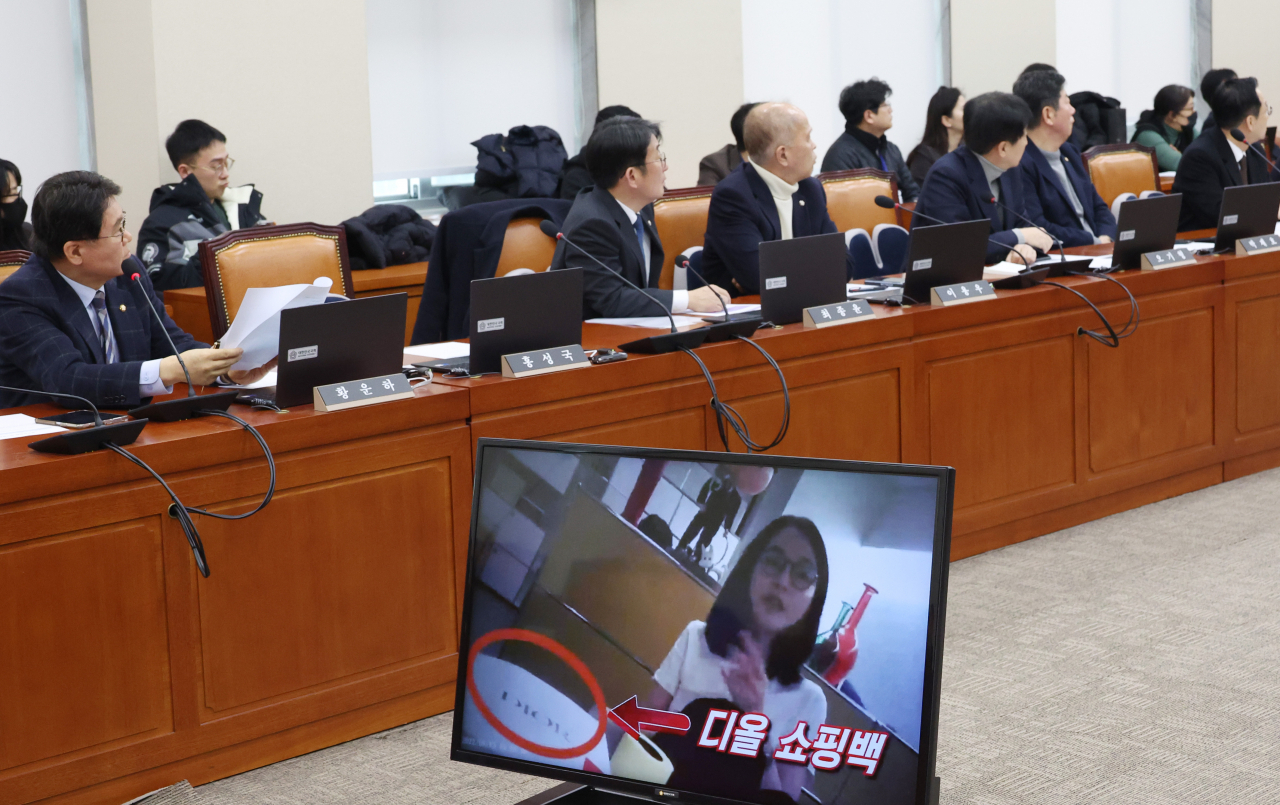 Democratic Party of Korea Rep. Hwang Un-ha speaks as the controversial video footage of first lady Kim Keon Hee accepting a Christian Dior bag from a pastor is being shown in the background during a meeting of the National Policy Committee at the National Assembly in Seoul on Monday. (Yonhap)