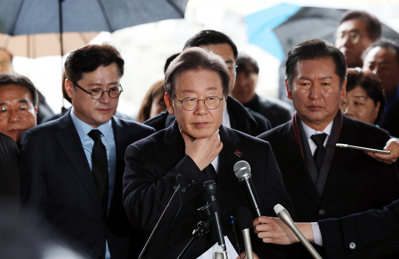 Democratic Party of Korea Chair Lee Jae-myung speaks to reporters during his visit to the graves of the victims of the 1980 Gwangju Uprising on Monday. (Yonhap)
