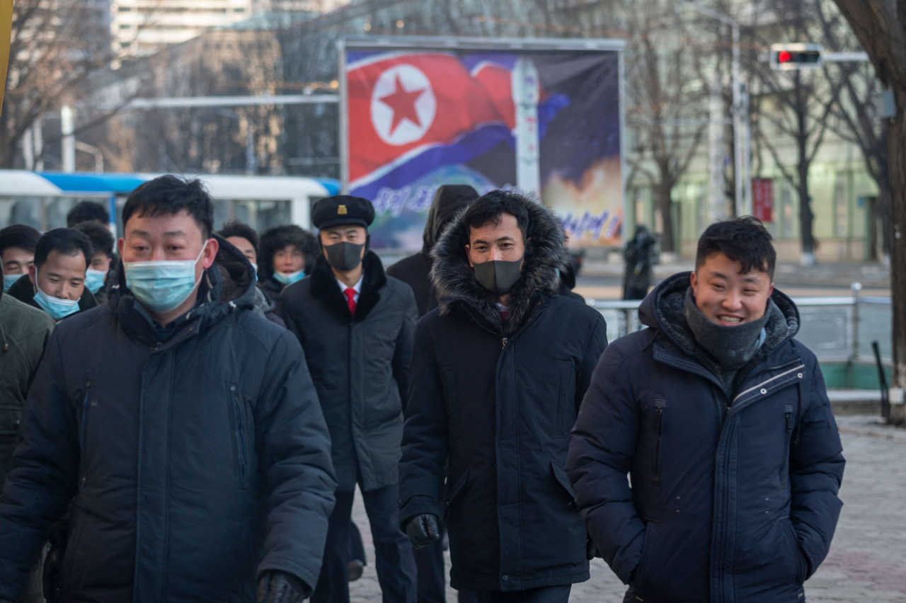 In this picture taken on January 23, 2024, people walk along Sungri street in Pyongyang. (AFP)