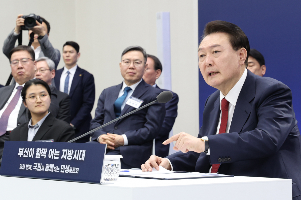 President Yoon Suk Yeol (right) speaks during a public debate held at Busan City Hall on Tuesday. (Yonhap)