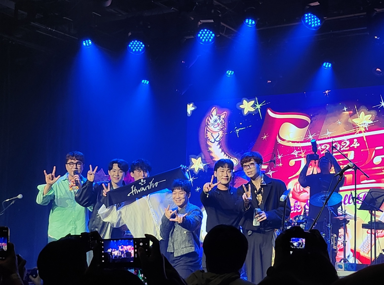 Members of Band Hwanho and Crying Nut’s bassist Han Kyung-rok (fourth from left) pose for a photo during the Kyugrockjeol concert held at Musinsa Garage, Mapo-gu, Seoul, Tuesday. (Lee Jung-youn/The Korea Herald)