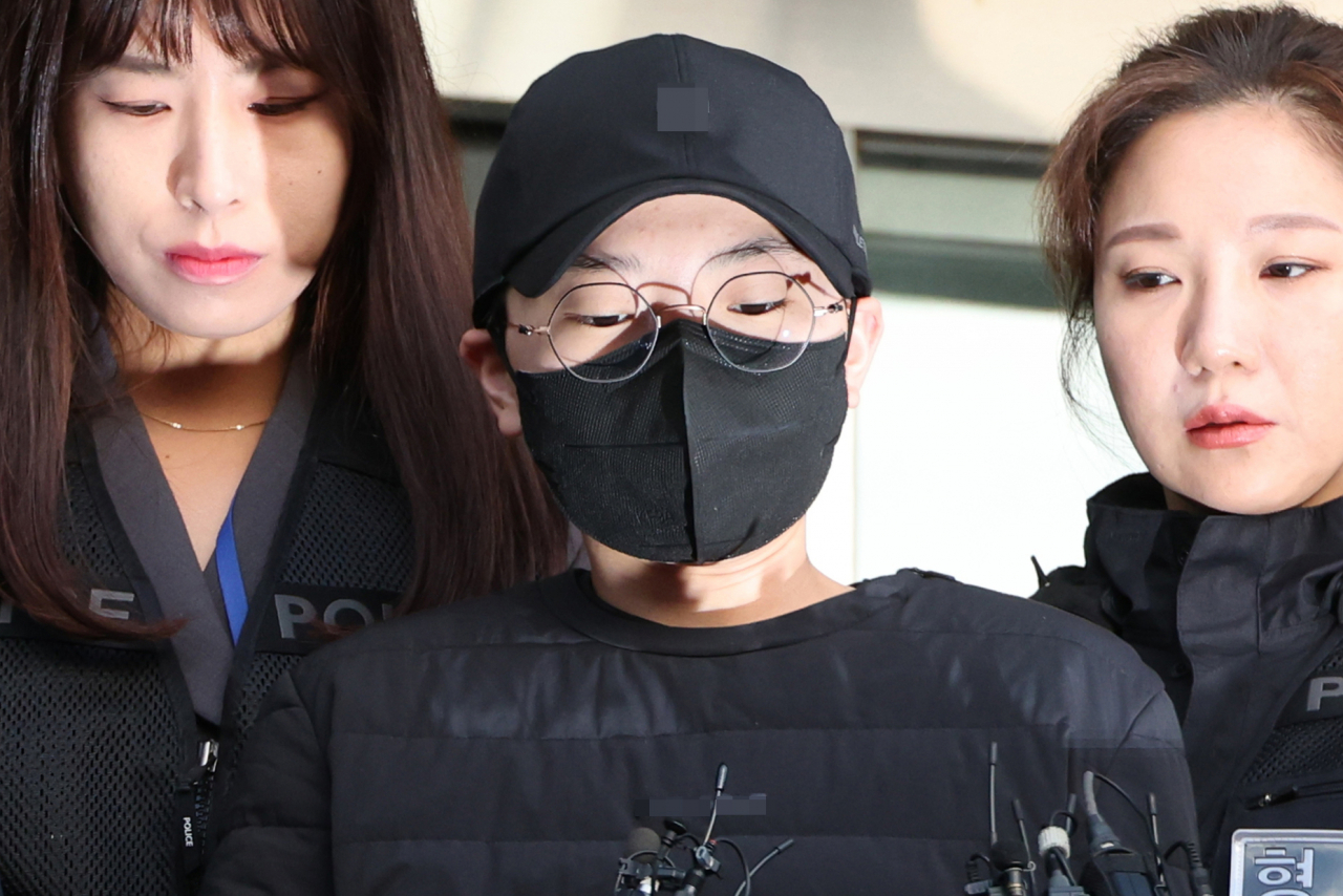 Jeon Cheong-jo, the 28-year-old former fiance of Olympic fencing medalist Nam Hyun-hee, is moved to the Seoul Eastern District Court for a trial on Feb. 14, 2024. (Yonhap)