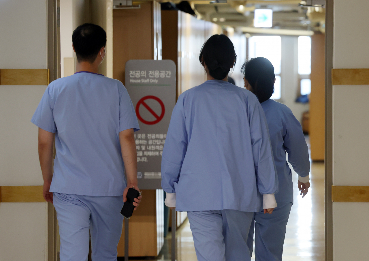 Medical personnel walk in a corridor at one of the five major hospitals in Seoul that gave notice of possible collective action in response to the government's recent move to increase the medical school enrollment quota. (Yonhap)