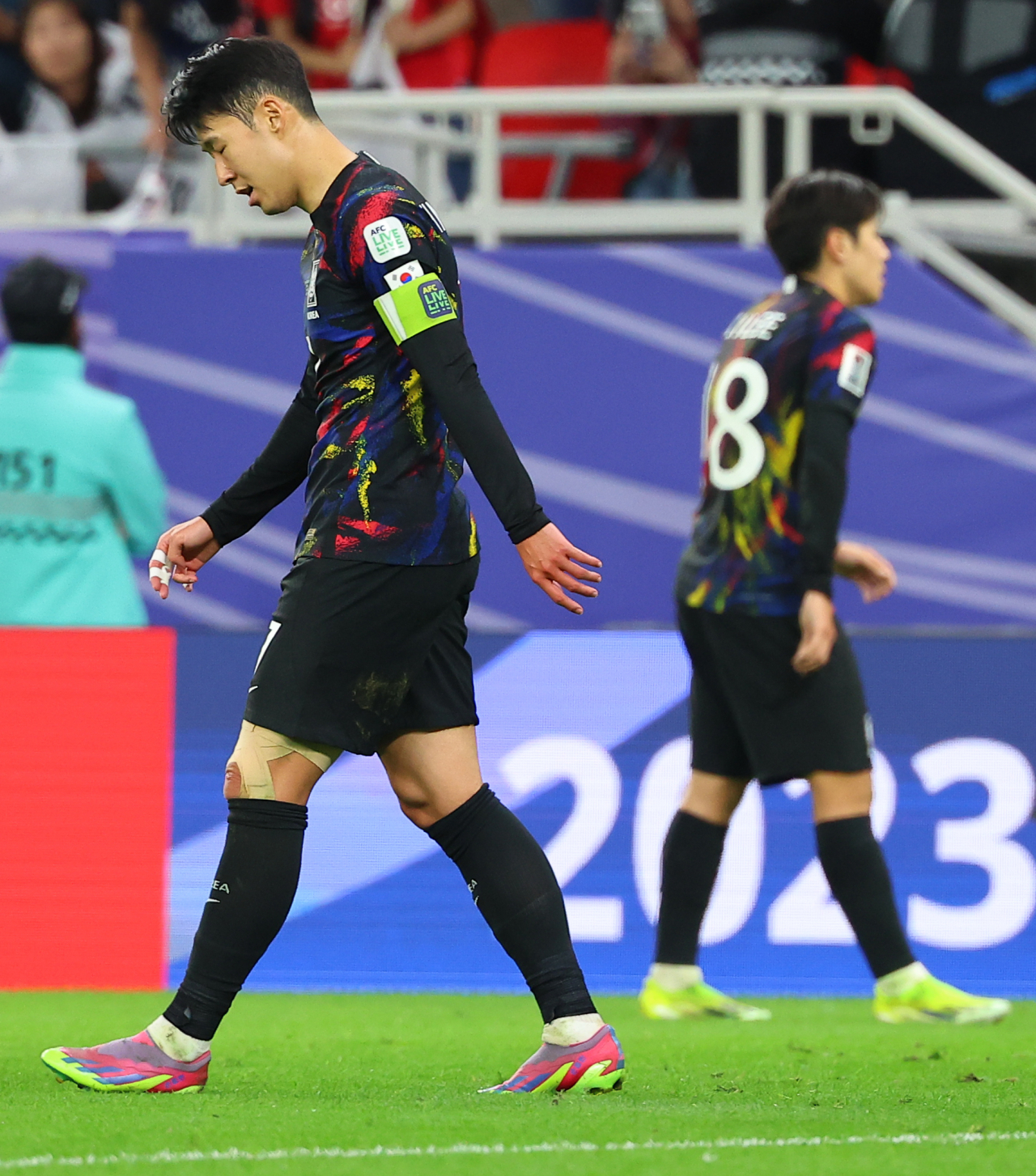 Son Heung-min (left) and Lee Kang-in walk off the field after South Korea lost 2-0 in the semifinal match against Jordan at the Asian Football Confederation Asian Cup at Ahmad bin Ali Stadium in Al Rayyan, Qatar on Feb. 6, 2024. (Yonhap)