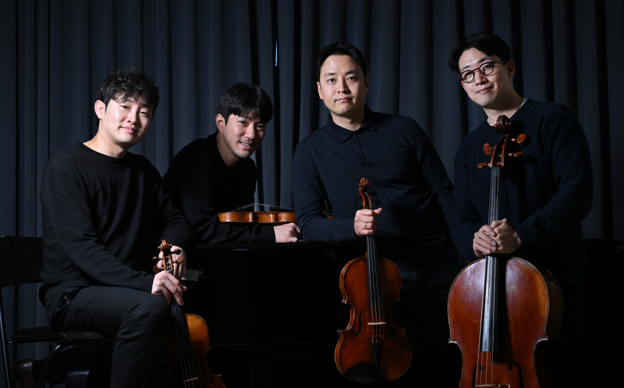 (From left) Members of the Novus String Quartet -- violinists Kim Jae-young and Kim Young-uk, violist Kim Kyu-hyun and cellist Lee Won-hae -- pose for photos during an interview with The Korea Herald on Monday. (Im Se-jun/The Korea Herald)