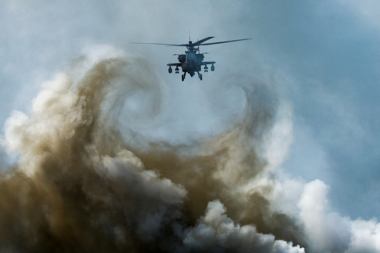 A military helicopter flies during an amphibious assault exercise as part of the 