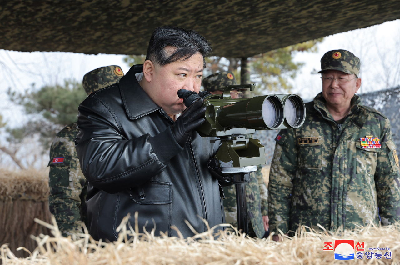 This photo, provided by North Korea's official Korean Central News Agency on Friday, shows North Korean leader Kim Jong-un watching a firing drill by the North Korean Army's front-line combined artillery units 