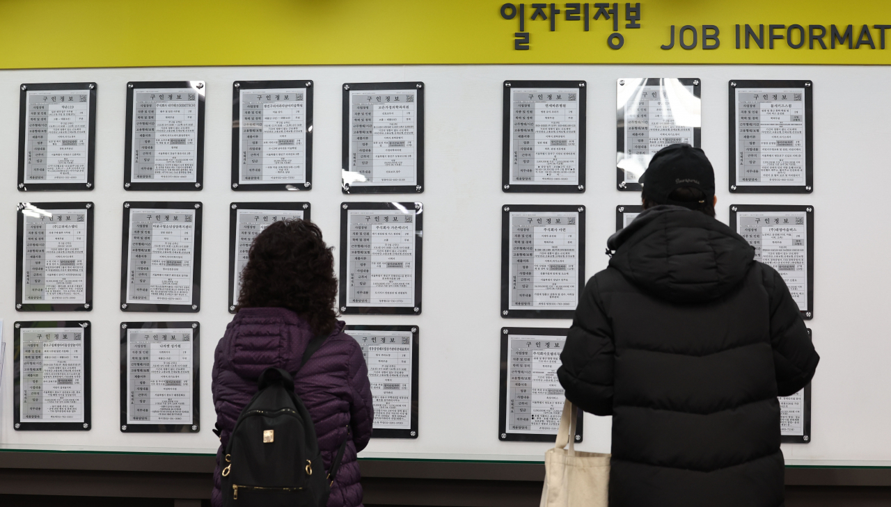 Jobseekers check job posts at a public welfare center in Seoul on Feb. 16, 2024. (Yonhap)