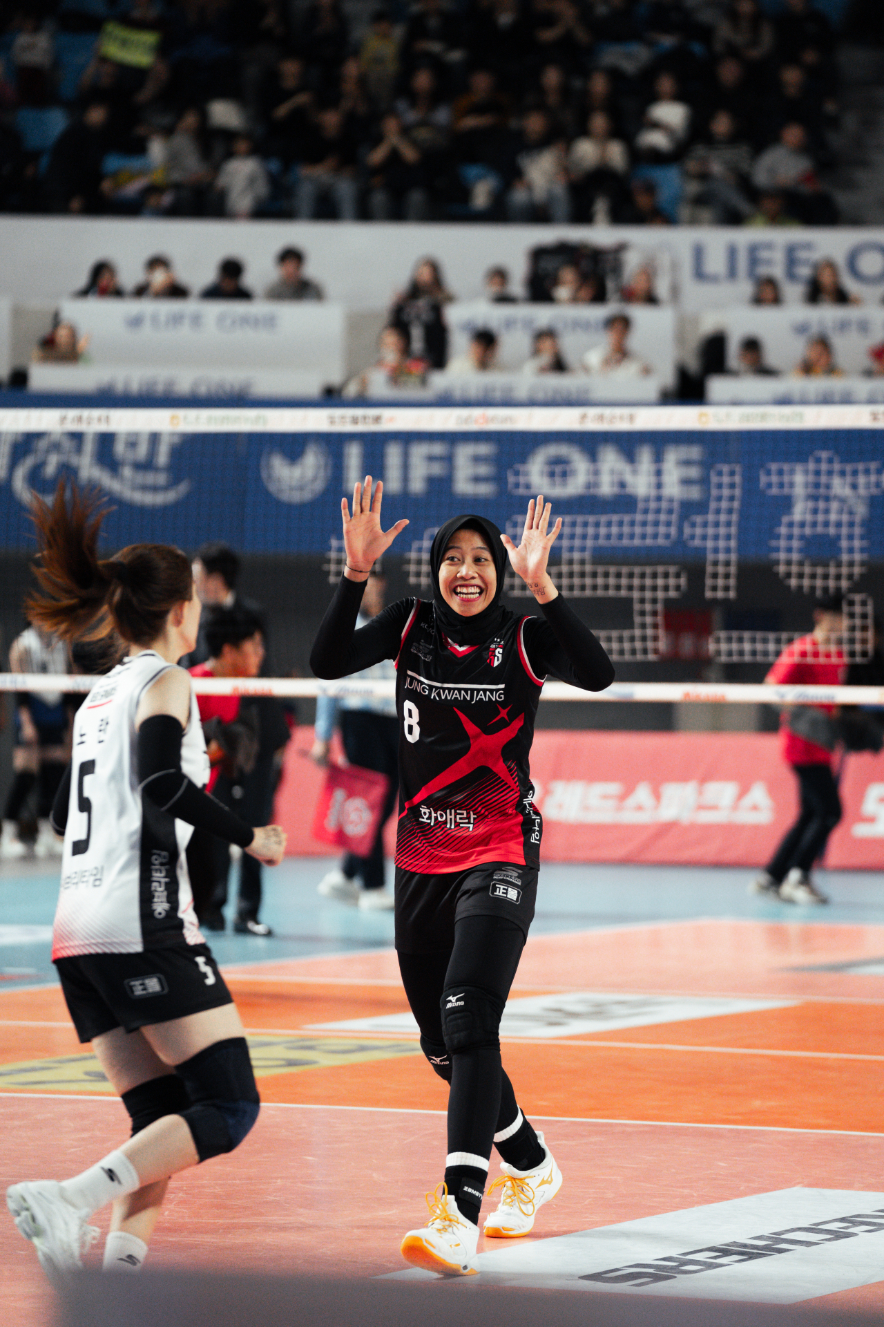 Megawati Hangestri Pertiwi raises her hands for a double high-five with Red Sparks teammate Ran Noh, at Chungmu Gymnasium in Daejeon on Feb. 4. (Hugh Hong/The Korea Herald)
