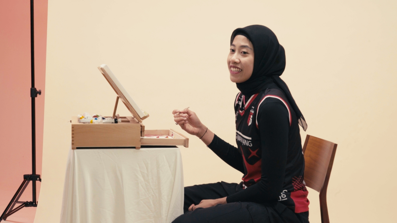 Megawati Hangestri Pertiwi paints and talks during an interview for the 