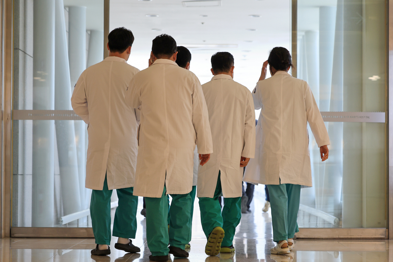 A group of doctors walk together at a hospital in Seoul in this photo taken on Wednesday. (Yonhap)