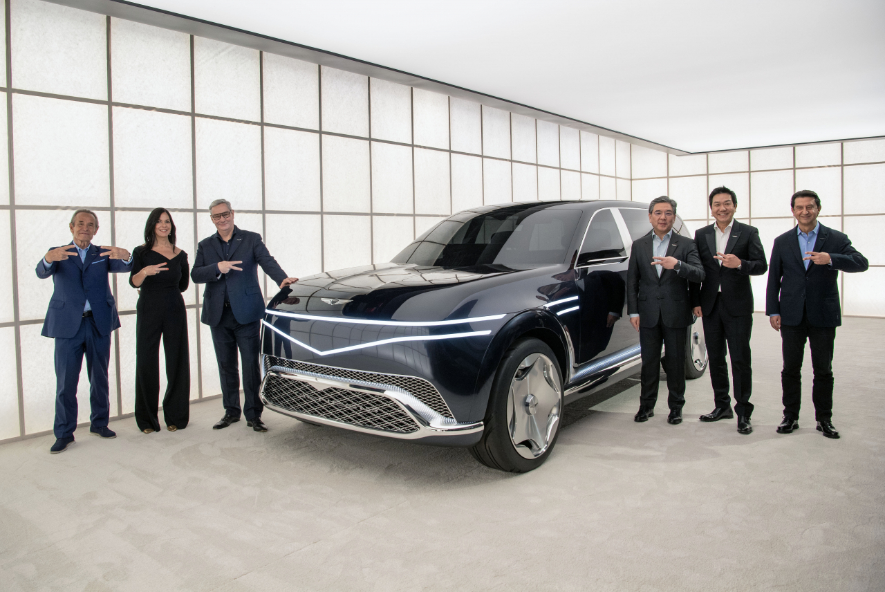 From left: Formula One racer and brand partner of Genesis Jacky Ickx; Claudia Marquez, chief operating officer at Genesis Motor North America; Luc Donckerwolke, chief creative officer at Genesis; Chang Jae-hoon, chief executive officer of Hyundai Motor Company; Lee Sang-yup, head of Hyundai Genesis Global Design Center; and Jose Munoz, Hyundai Motor global chief operating officer, pose for a photo with full-electric Neolun concept car at Genesis House New York on Monday. (Genesis)