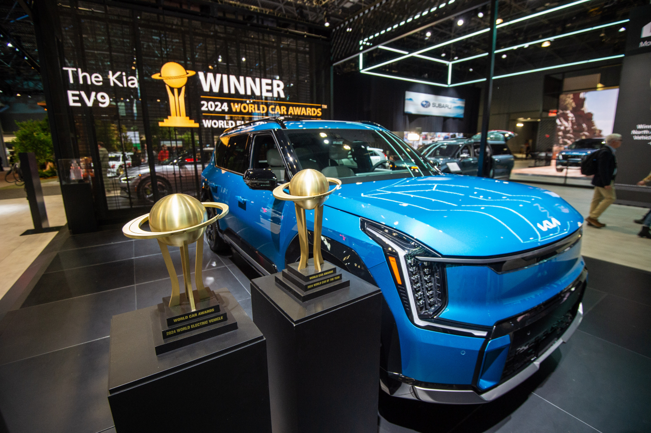 The Kia EV9 is displayed with the World Car of the Year and World Electric Vehicle of the Year trophies at the New York International Auto Show on Wednesday. (Hyundai Motor Group)