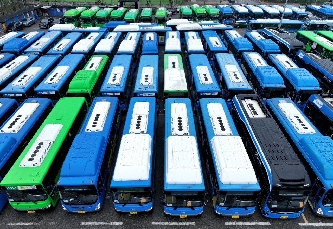 Intracity buses are parked in a parking lot in Seoul, following a general strike declared by unionized bus drivers demanding an increase in wages Thursday. (Yonhap)