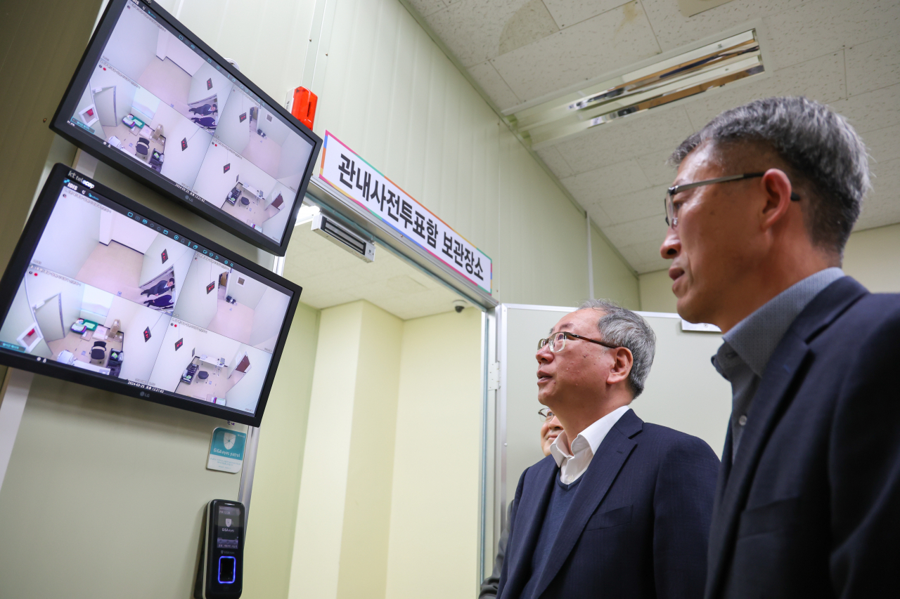 Officials from the South Gyeongsang Province branch of the National Election Commission in Changwon city inspect footage from illegal surveillance cameras installed inside polling stations, Wednesday. (Courtesy of the South Gyeongsang Province branch of the NEC)