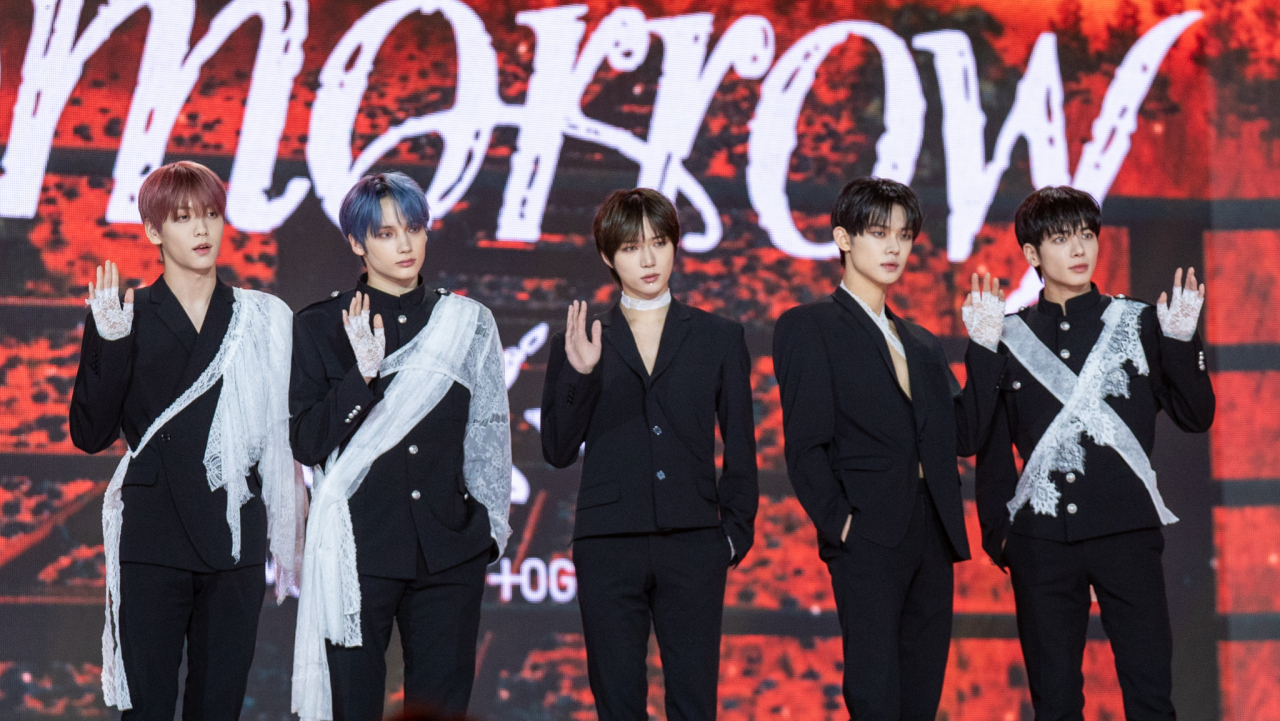 From left: TXT members Soobin, Hueningkai, Beomgyu, Yeonjun and Taehyun pose for a photo during a press conference held at the Korea University’s Hwajung Gymnasium, Monday. (Hwang Yun-ha/The Korea Herald)