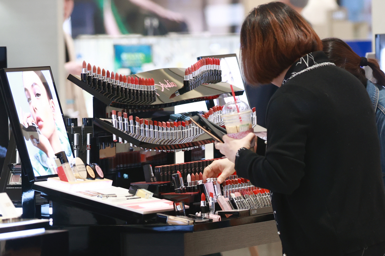 Customers at a cosmetics store in a department store located in Seoul (Yonhap)