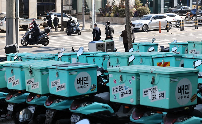 Delivery motorcycles operated by food delivery app Baedal Minjok are parked at a delivery center in Seoul. (Yonhap)