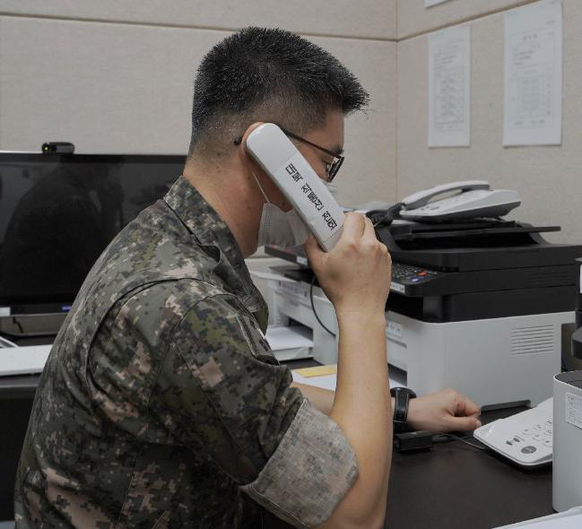 A South Korean officer talks to his North Korean counterpart using a military hotline on July 27, 2021. (Defense Ministry)