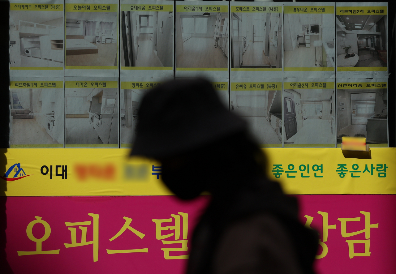 Advertisements for homes are displayed in a real estate agent's office window in Seoul, March 17. (Yonhap)