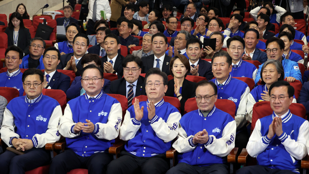 Members of the main opposition Democratic Party of Korea cheer at the National Assembly in Seoul, after exit poll results for the 2024 general election were announced at 6 p.m. on Wednesday. (Yonhap)
