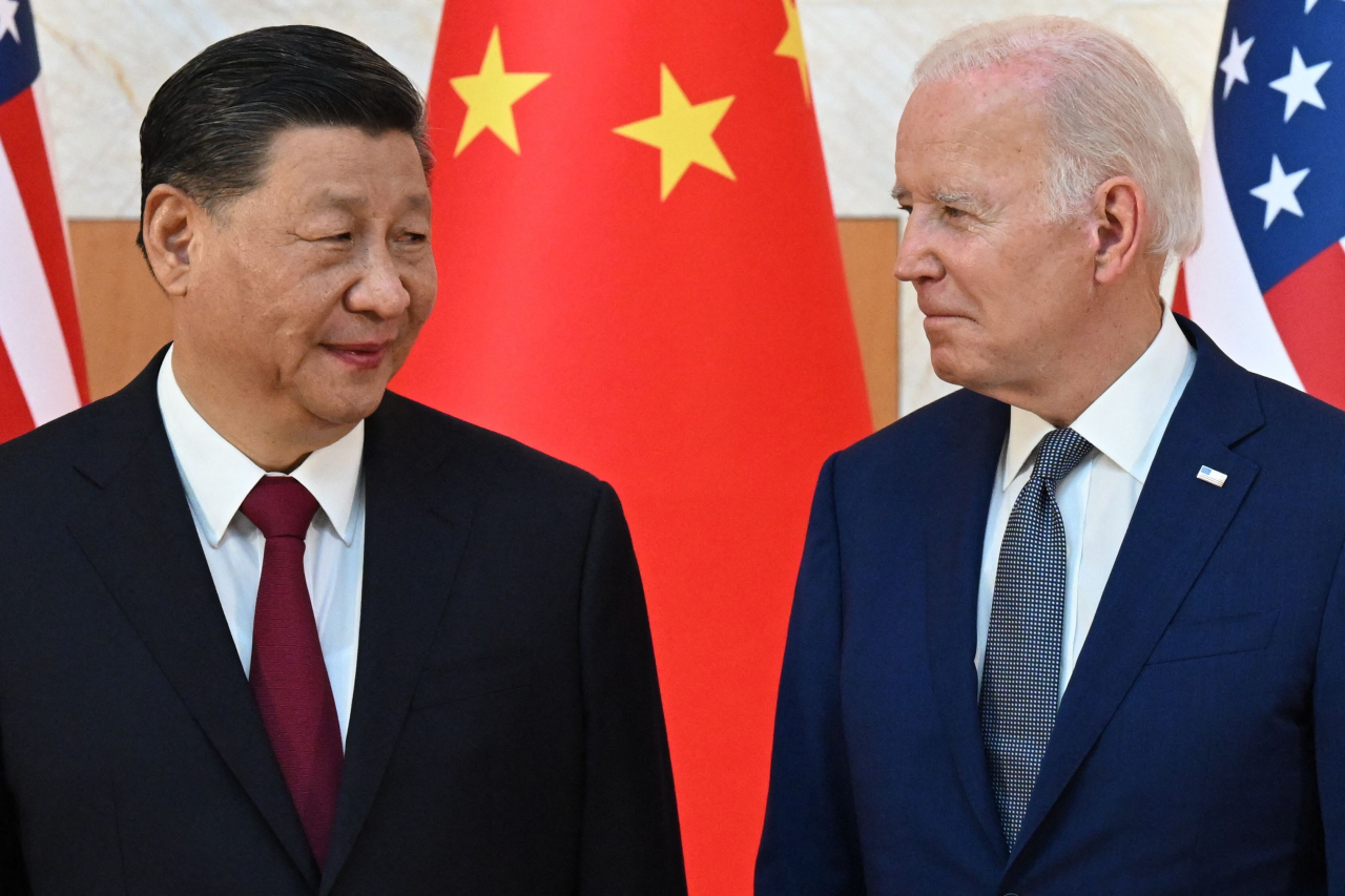 US President Joe Biden (right) and China's President Xi Jinping meet on the sidelines of the Group of 20 Summit in Nusa Dua on the Indonesian resort island of Bali, November 14, 2022. (AFP)