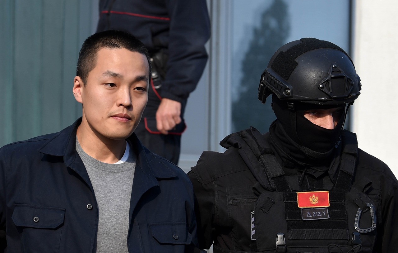Police officers escort crypto mogul Do Kwon (left) to a holding facility for foreigners pending his extradition, in Podgorica, Montenegro, Tuesday. (EPA-Yonhap)