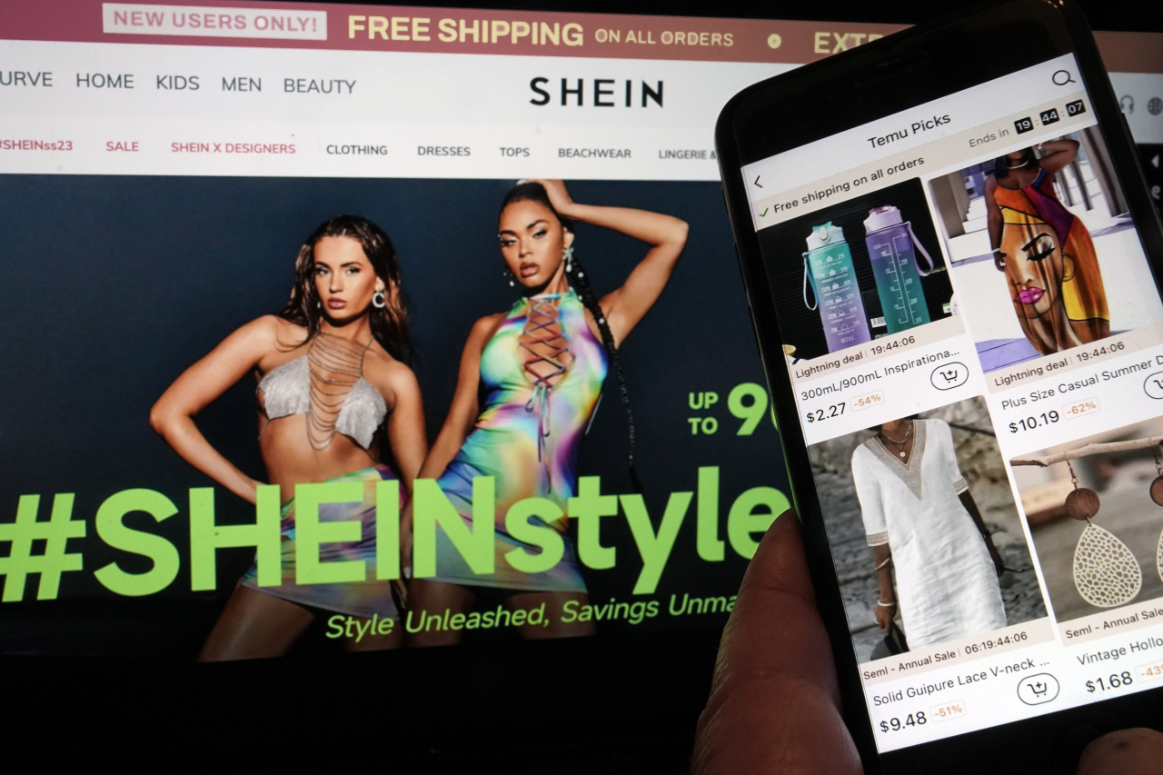 Pages from the Shein website, left, and from the Temu site, right, are shown in this photo, in New York. (AP-Yonhap)