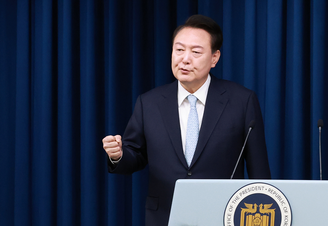 President Yoon Suk Yeol answers reporters' questions after introducing his new senior secretary for civil affairs at the presidential office in Seoul on Tuesday. (Yonhap)