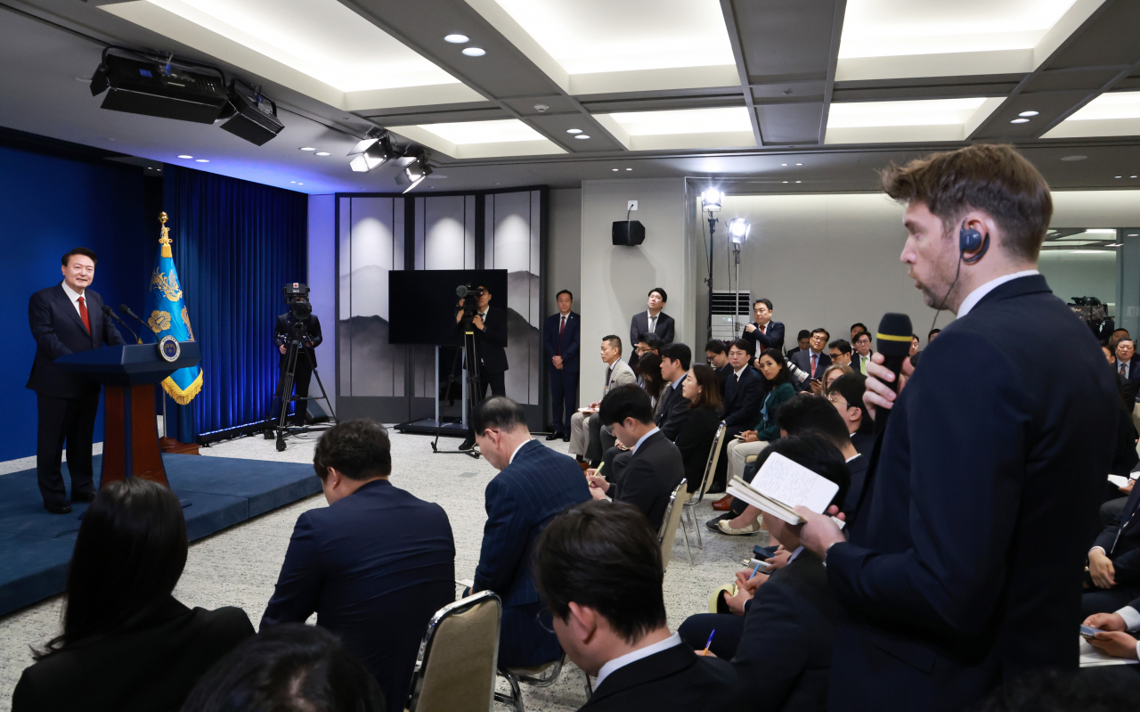 President Yoon Suk Yeol takes questions from a reporter during a news conference in Seoul on Thursday. (Yonhap)