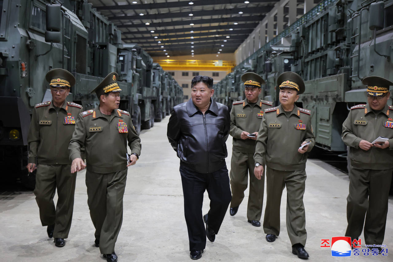 North Korean leader Kim Jong-un (center) inspects a new tactical missile weapons system, to be newly equipped by the combined missile units of the Korean People's Army, at an undisclosed site on Tuesday. (KCNA)