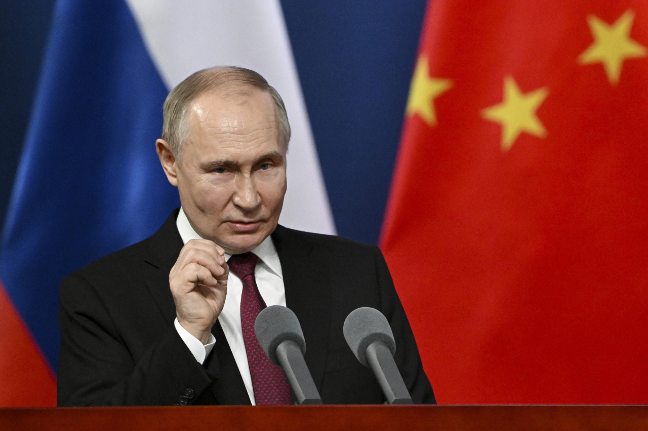 Russian President Vladimir Putin gestures as he talks with students of the Harbin Institute of Technology in Harbin, northeastern China's Heilongjiang Province, on Friday. (AP-Yonhap)