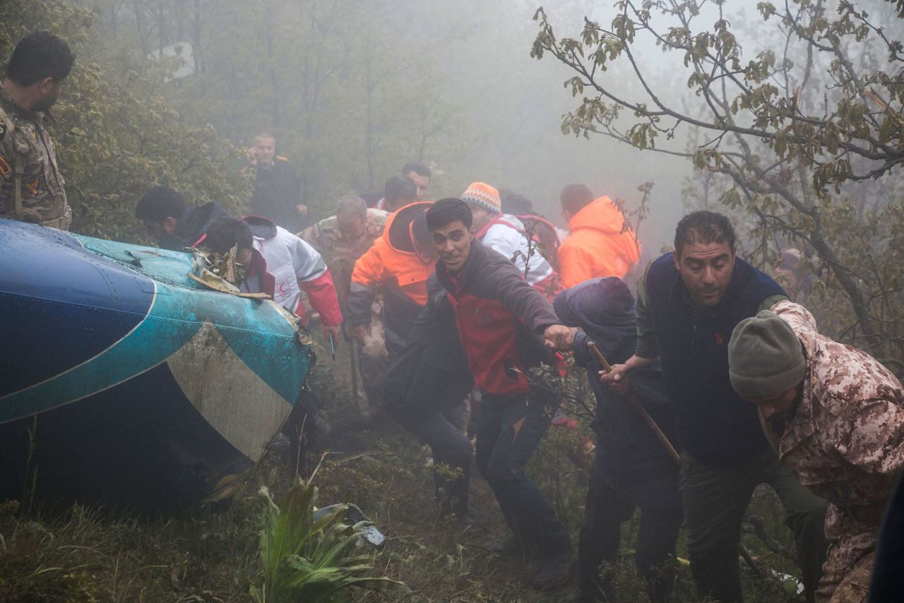 Rescue team members work at the crash site of a helicopter carrying Iranian President Ebrahim Raisi in Varzaghan, in northwestern Iran Monday. (AFP-Yonhap)